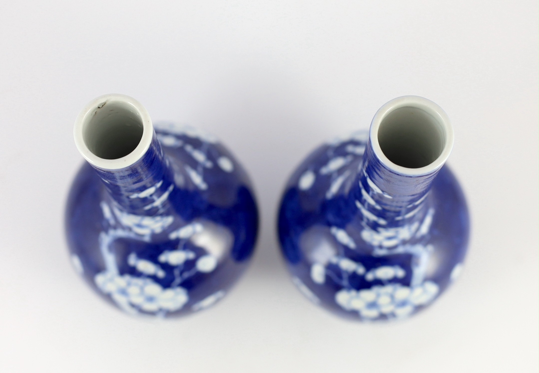 A pair of Chinese blue and white prunus bottle vases, early 20th century, 26cm